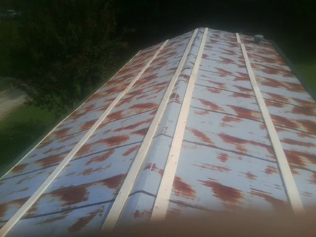 Rusted metal roof panels with new wood purlins before replacement — Storm Damage Roof Repair in Darlington by Roofing Brothers