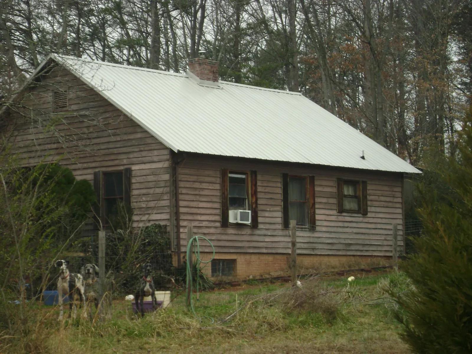 White metal roof on an old wood sided farmhouse, from a Metal Roof Installation job in Darlington